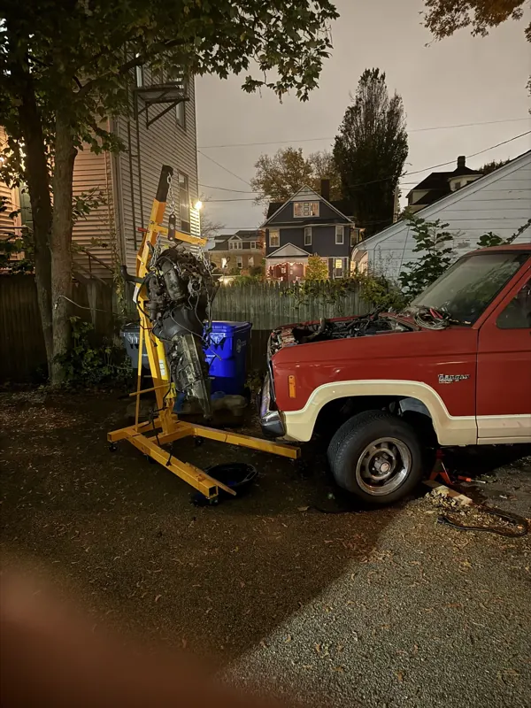 1986 Ford Ranger during its electric truck conversion with the gas engine pulled out on a hoist